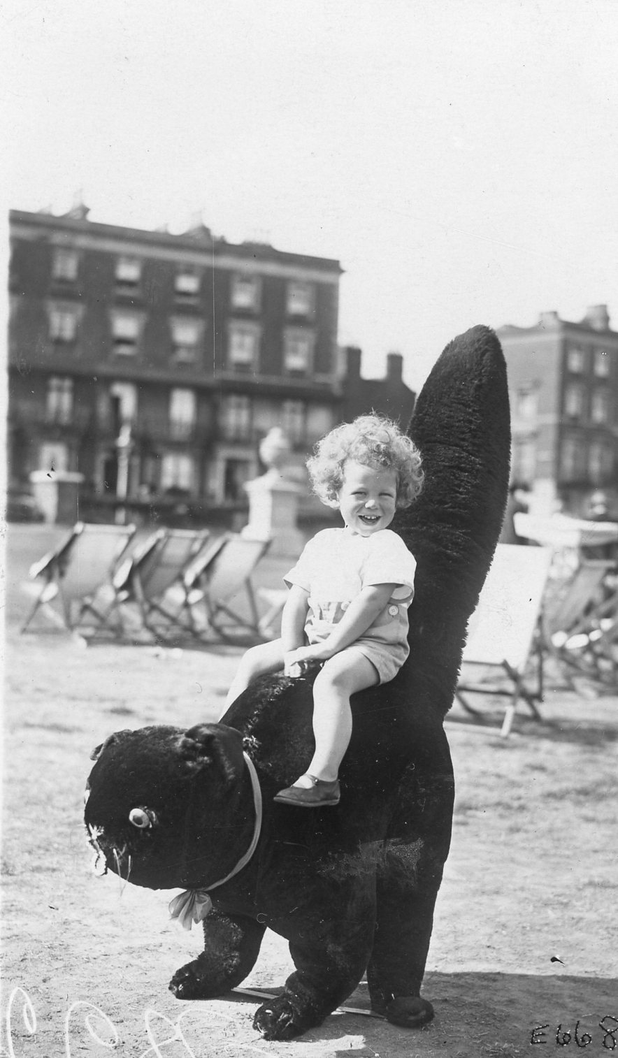 Roy age ~2 at Clifton Baths, Margate. Handwritten on reverse: "Don't you Dearest Mother think this is a fine photo, there was a crowd of people looking on at him when this was taken because the photographer told him to laugh, and you can see he did")