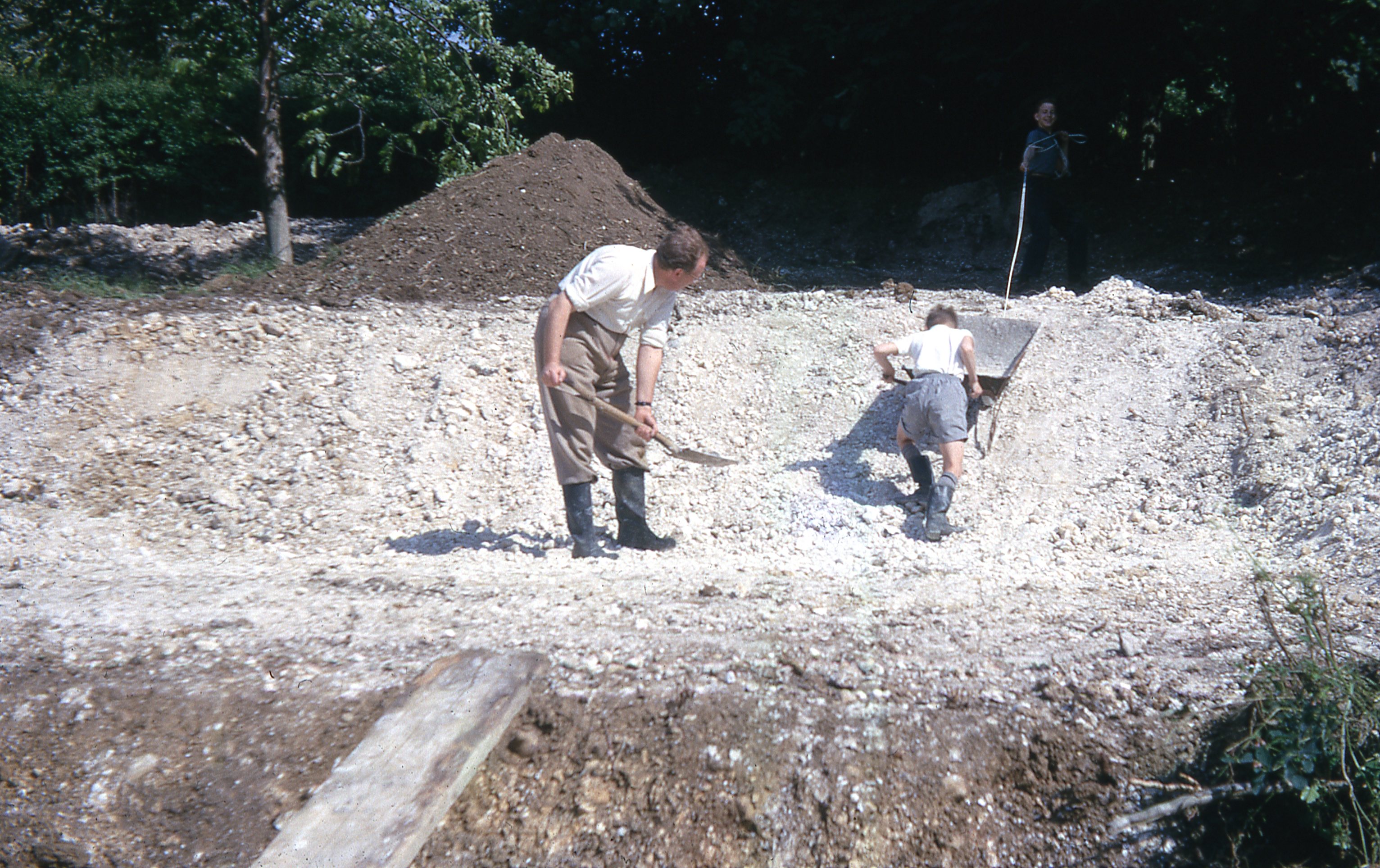 Paul & Graham helping thier father Roy landscape the back garden, July 1963