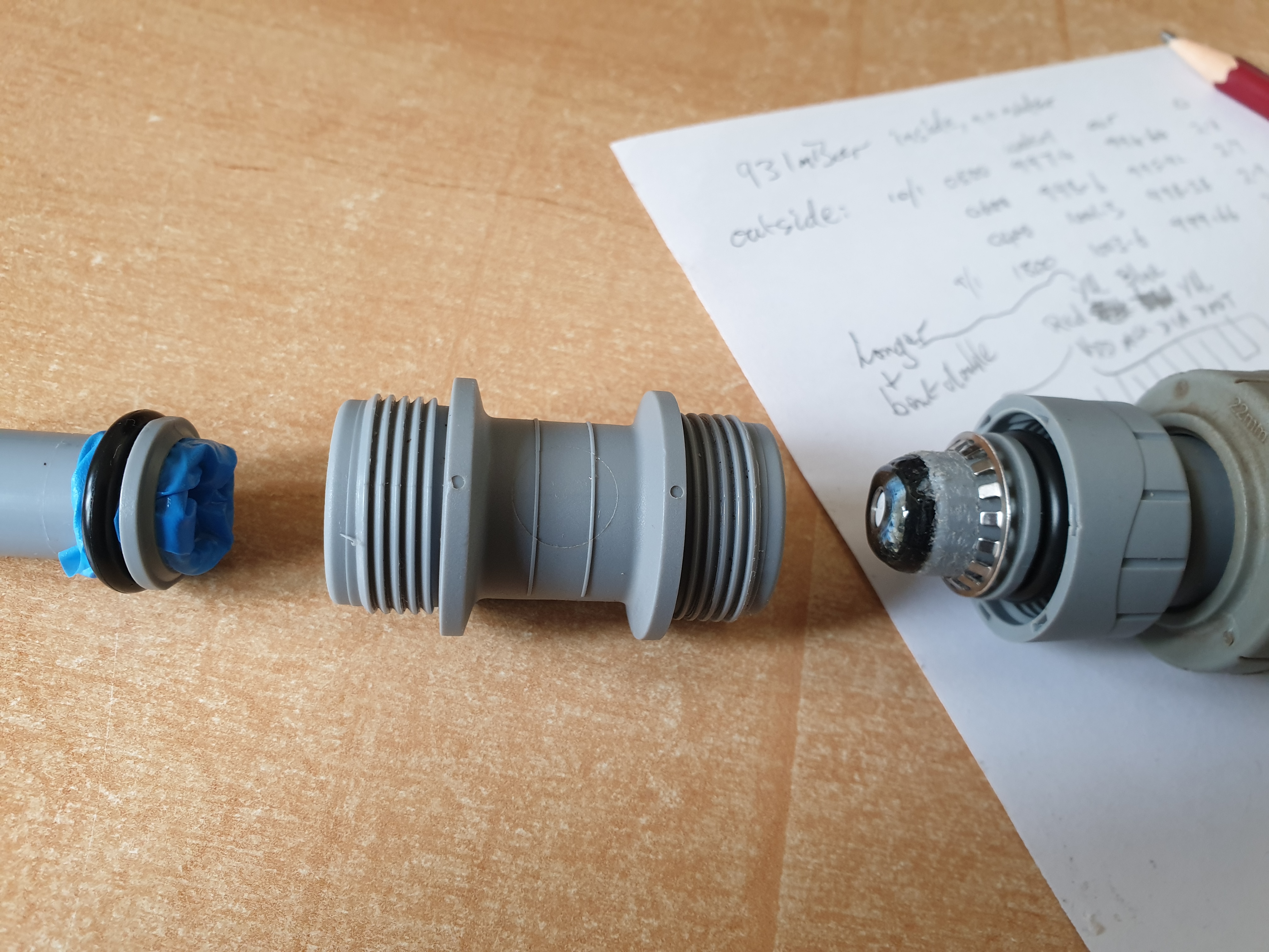 Nitrile finger (left), pipe coupler (centre), & sensor (right) before assembly & filling with silicone oil